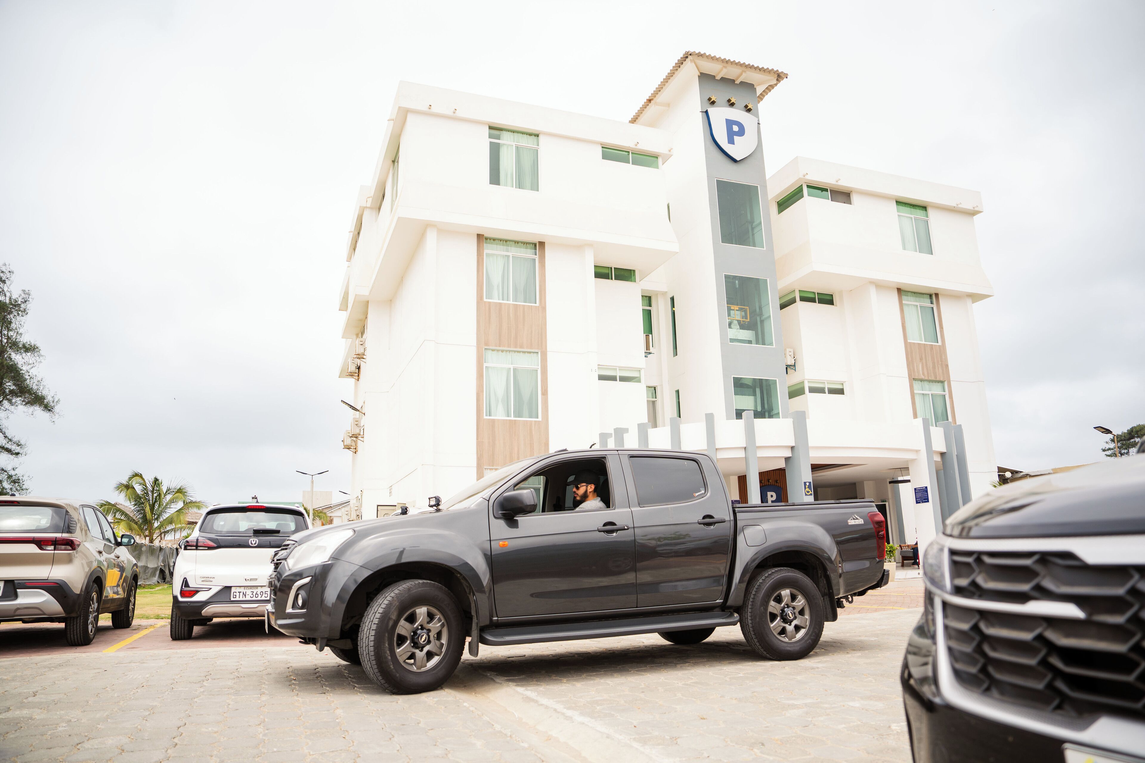 A multi-story hotel with a parking garage.