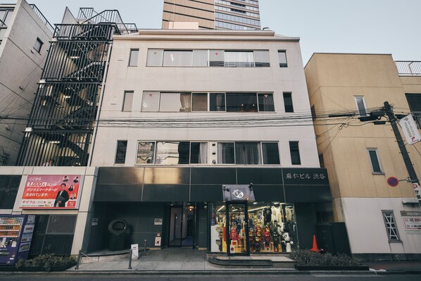 A multi-story building with a storefront at the ground level.