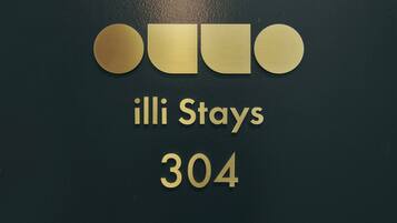 A sign with the text "illi Stays 304" on a dark background.