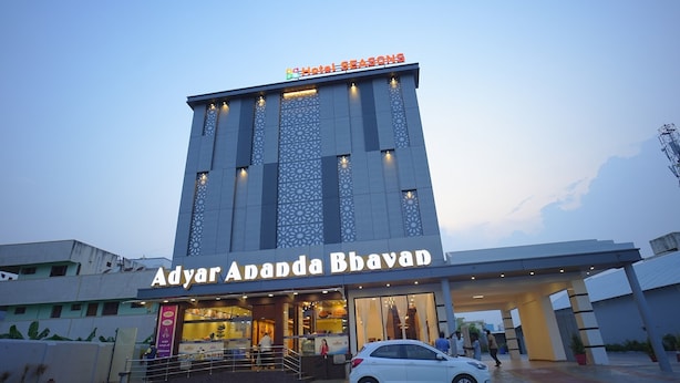 A hotel named Adyar Ananda Bhavan with a modern facade and a visible entrance. - Hotel Seasons (Tiruvannamalai)
