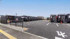 A parking lot with rows of portable cabins labeled "The Yard." - HOTEL R9 The Yard Karatsu (Karatsu)
