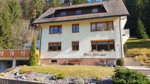 A two-story building with a sign reading 'Haus Johanna,' featuring a balcony, multiple windows, and a stone facade. - Apartment 'Haus Johanna' with Mountain View, Balcony and Wi-Fi (Todtmoos)
