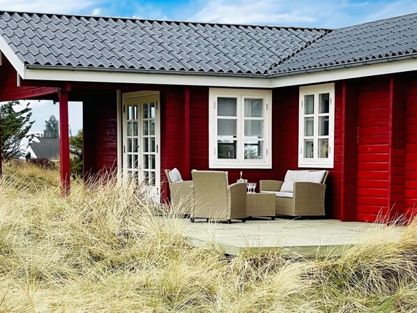Enjoy a peaceful retreat in this charming home surrounded by lush greenery.