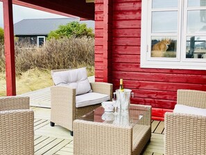 Relax and socialize in this outdoor seating area with wicker furniture and a table for gatherings.