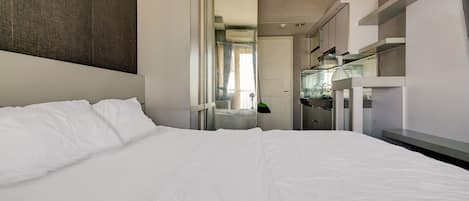 Laptop workspace, bed sheets