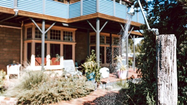 A building with a wooden deck and a water feature. - The most beautiful guest retreat (Break O'Day)
