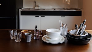 A kitchen counter with various dishes, glasses, and utensils. - Gram Cottage Hakuba (Hakuba)