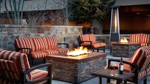 An outdoor seating area with fire pits and striped cushions. - Ski-in Ski-out - Family Friendly - Sleeps 6 - Marriott's Mountain Valley Lodge (Breckenridge)