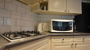 Een koelkast, een magnetron, een kookplaat, een vaatwasser