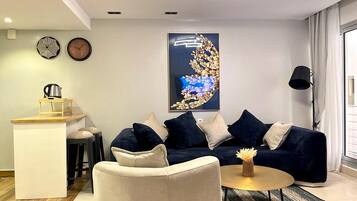 Standard Apartment | Living area | 42-inch Smart TV with cable channels