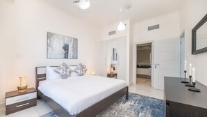 Una camera da letto moderna con un letto grande, comodini, un tavolino e uno specchio.