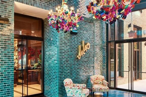 Step into a vibrant lobby with artful chandeliers and lounge seating.
