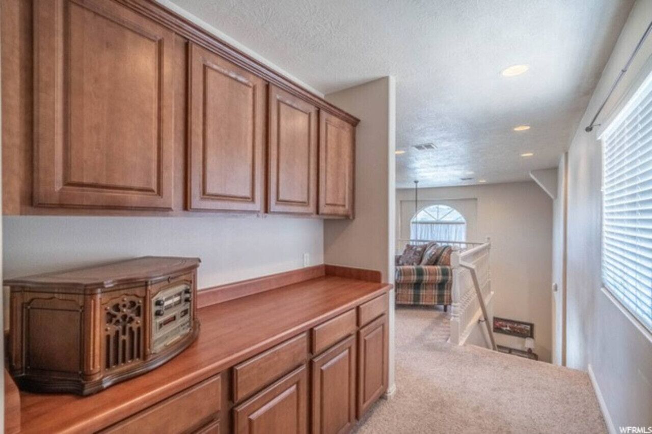 A kitchen with wooden cabinets and a vintage radio.