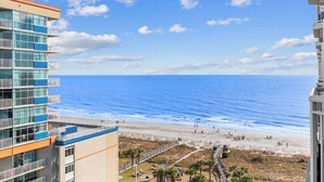 A high-rise building with a view of the beach and ocean.