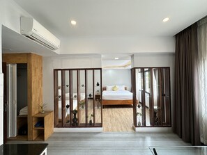 Deluxe Triple Room, 1 Bedroom, Balcony, City View | Minibar, in-room safe, desk, laptop workspace