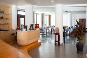 A spacious hotel lobby with a reception desk, seating area, and a view of the dining area. - SIEM REAP RIVER VIEW RESIDENCE (Siem Reap)