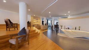 A spacious lobby with wooden flooring, a reception desk, and seating areas. - SIEM REAP RIVER VIEW RESIDENCE (Siem Reap)