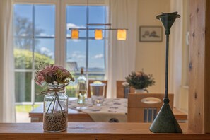 Enjoy a warm and inviting dining area with a beautiful view, a wooden table, and comfortable seating.