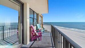 Un balcon avec vue sur la plage et l’océan.