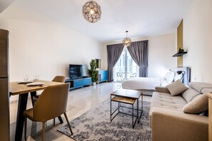 Relax in a stylish room with a large bed, flat-screen TV, and dining area.