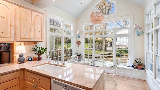 A spacious kitchen with large windows, wooden cabinets, and a central island. - Walk to Town |Hot Tub |Chef Kitchen - The Sunny Spot (Decatur)