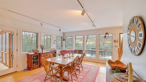 A spacious dining area with a large wooden table, chairs, and a rug. - Great Barrington Lakeside Getaway w/ Kayak & Grill (Great Barrington)