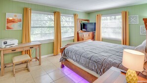 A bedroom with a bed, a desk with a printer, a television, and a lamp. - Patio & Grill: Idyllic Sorrento Vacation Home! (Sorrento)