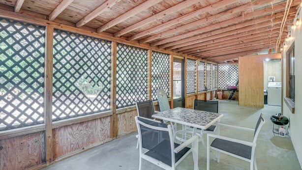 A covered outdoor area with a wooden ceiling, lattice walls, and a table with chairs. - Patio & Grill: Idyllic Sorrento Vacation Home! (Sorrento)