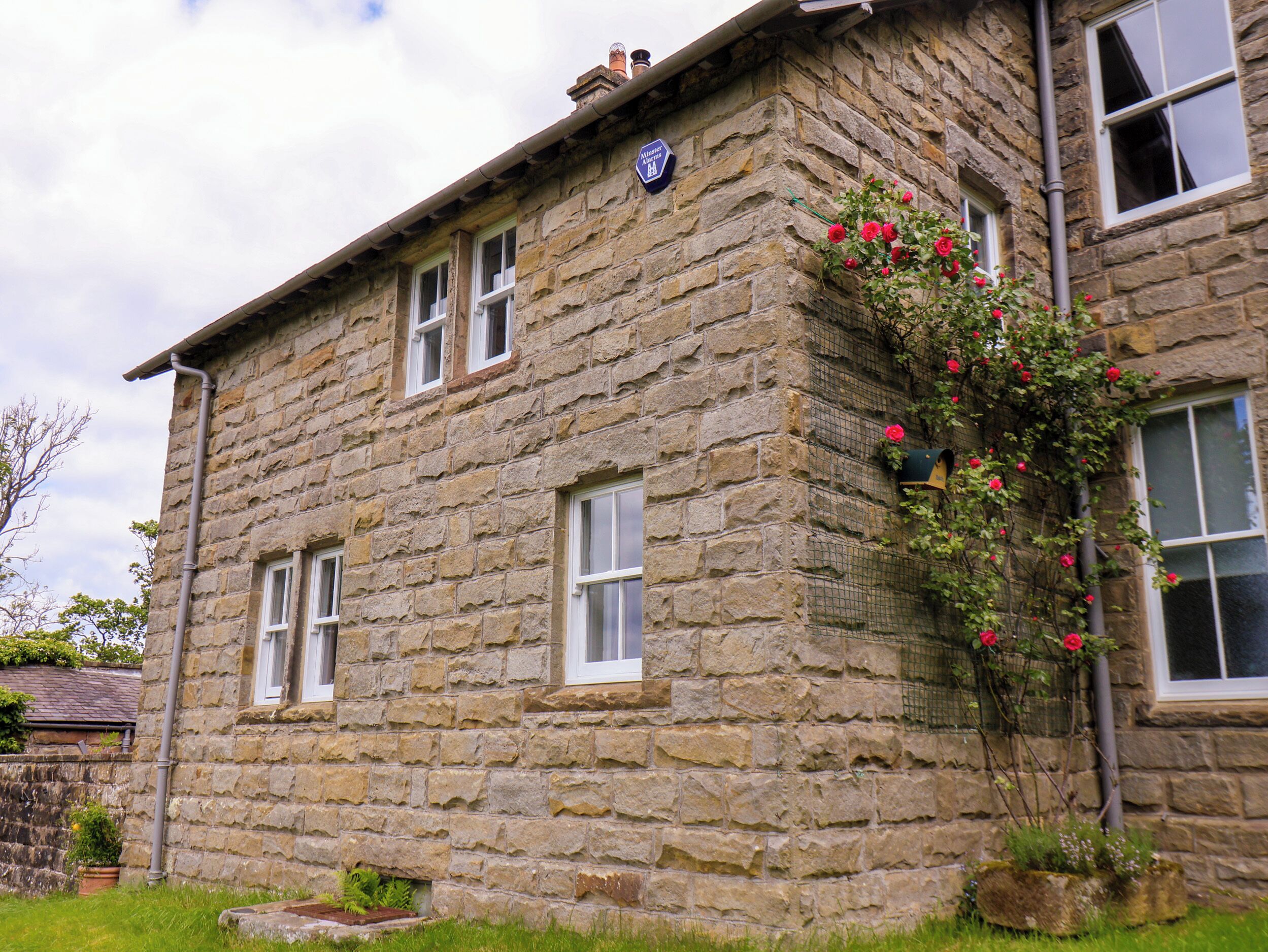 A stone building with a sign indicating it is a hotel.