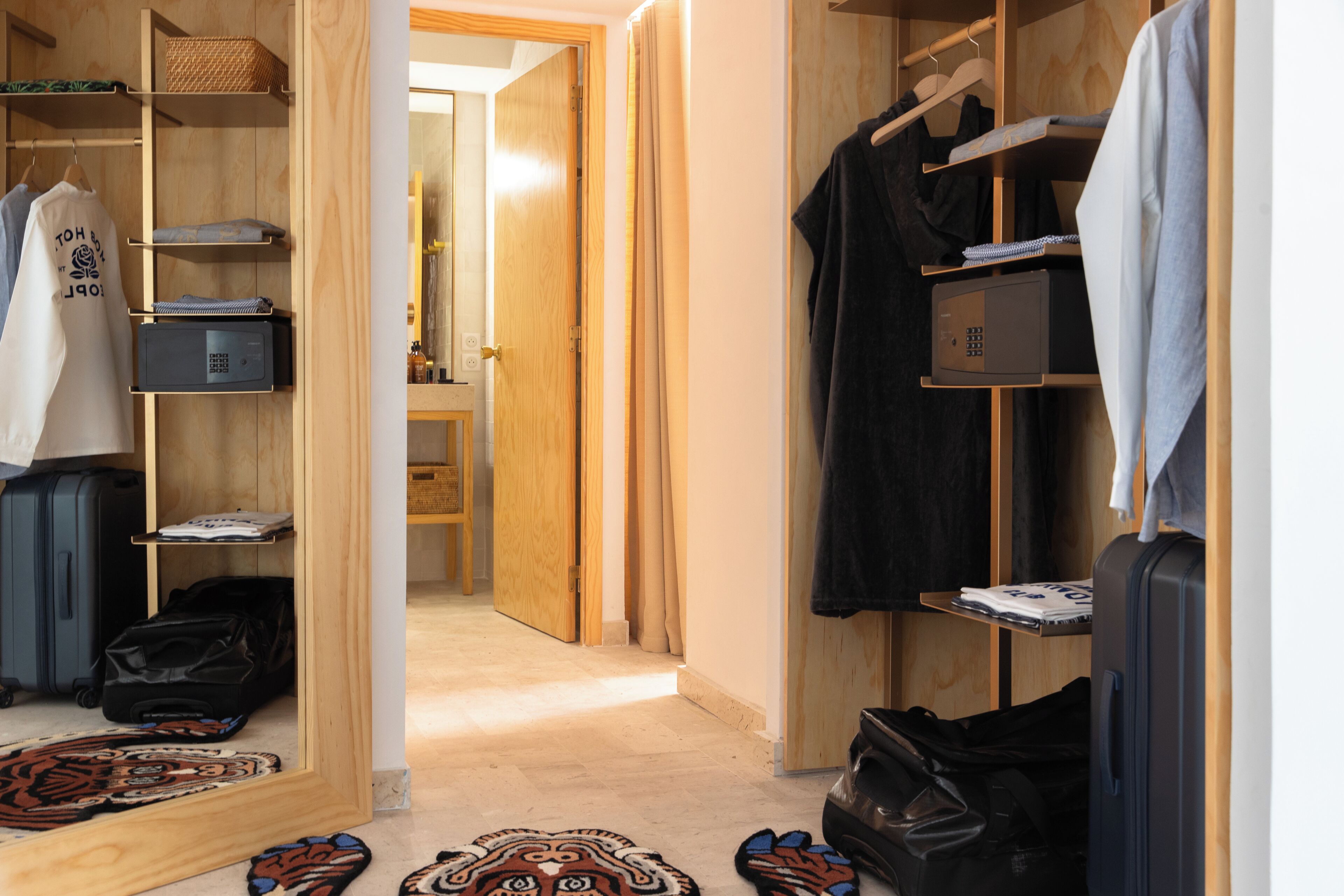 A walk-in closet with shelves, hanging space, and a shoe rack.