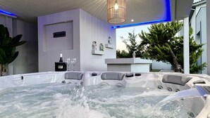 A hot tub area with a view of the outdoors, including a tree and a building. - Muthee Luxurious Private Villa  (Zakynthos)