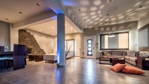 A spacious living area with a stone staircase, a large window, and a modern fireplace. - Muthee Luxurious Private Villa  (Zakynthos)