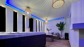 A modern kitchen with a large island, pendant lighting, and a seating area with a sofa and coffee table. - Muthee Luxurious Private Villa  (Zakynthos)