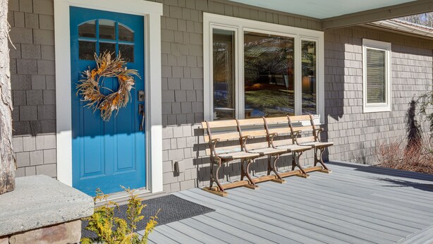 A house with a blue door, a wreath, and a bench outside. - Mountain Retreat w/ Deck: Near Blue Ridge Parkway (Blowing Rock)