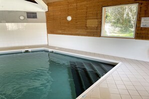 An indoor swimming pool with clear water, surrounded by tiled walls and wooden paneling. - Holiday Home on a French Island for 5 (Saint-Georges-d'Oléron)