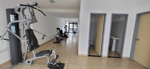 Relax in a spacious room with a large bed, separate seating area, and a window offering a view of the outside.
