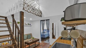 A kitchen with a wooden counter, a sink, and a hanging pot rack. - 1/1 Loft Villa 2 blocks to Beach (Deerfield Beach)