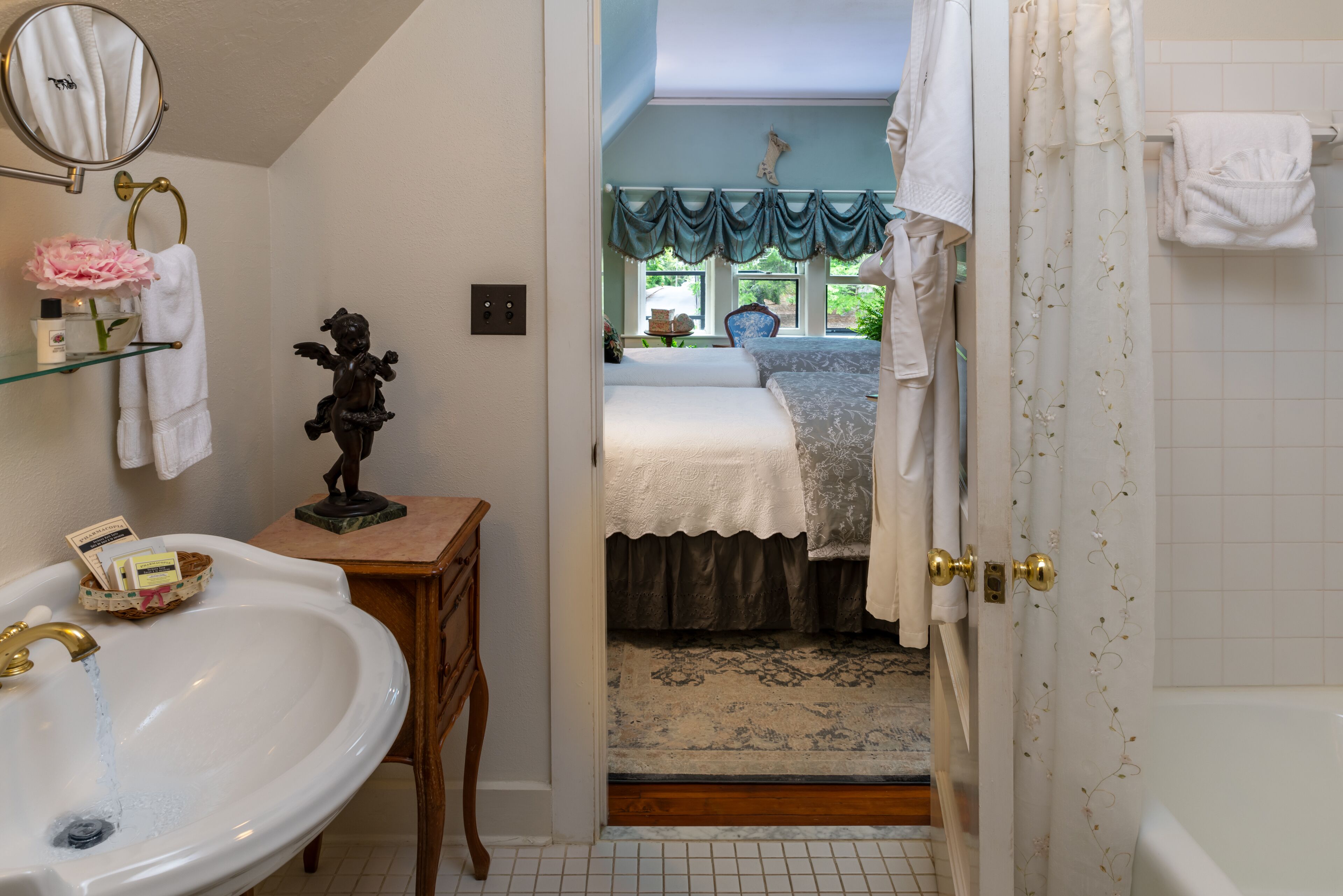 A bathroom with a sink, mirror, and towel rack.