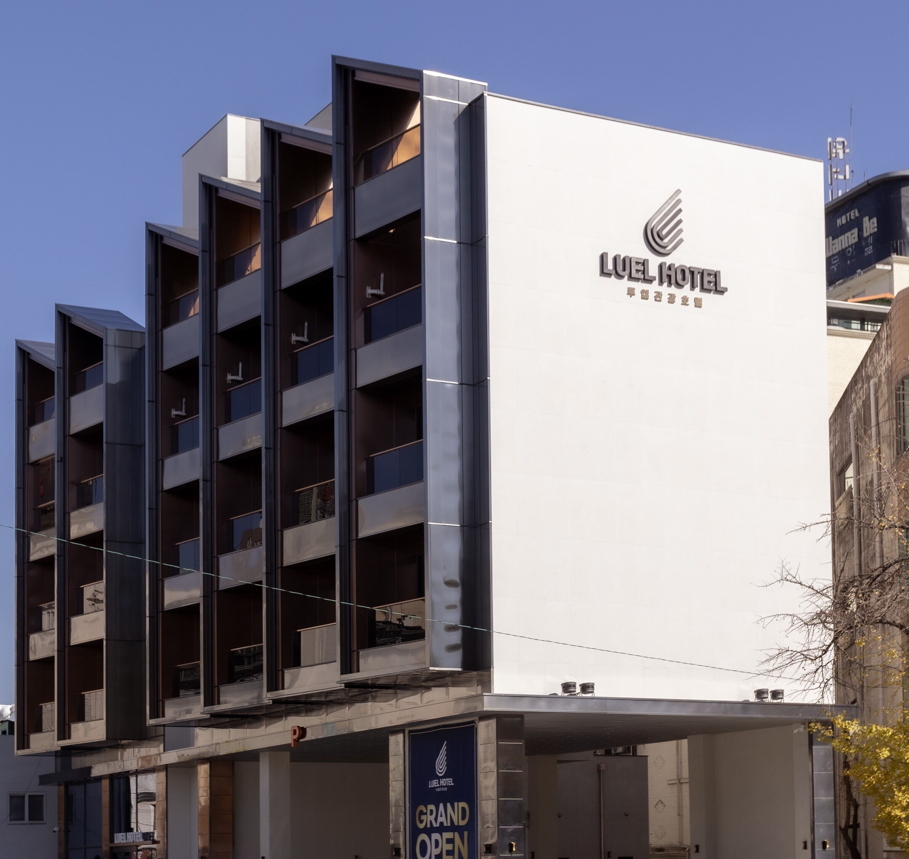 A modern hotel building with a prominent sign reading "LUEL HOTEL".