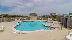 A swimming pool with a wooden fence, lounge chairs, and a 'No Diving' sign. - Beautiful semi-oceanfront townhouse near Kitty Hawk Pier! (Kitty Hawk)
