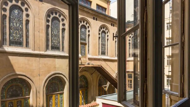 A building with arched windows and a staircase leading to an upper level. - Beautiful Apartment in Prague (Prague)