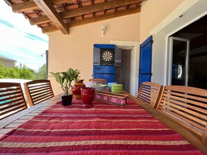 Enjoy dining al fresco amidst lush greenery and a beautifully set table.