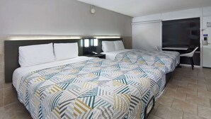 A hotel room with a large bed, a desk, and a chair. - Studio 6 Mesquite, Tx – Town East (Mesquite)