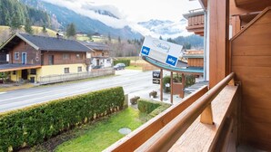 A mountain view with a sports bar named 'Schang' and a wooden building with a balcony. - Apartment in Wald near Zillertal Ski Slopes (Wald im Pinzgau)