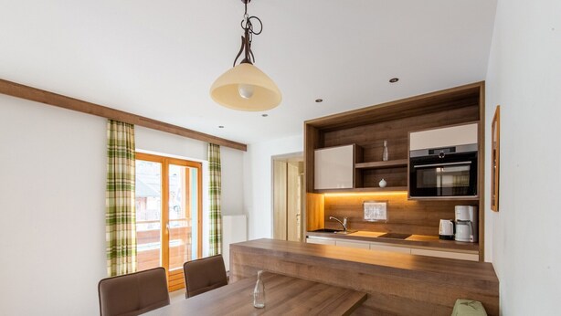 A modern kitchen with a built-in oven, microwave, and coffee maker. - Apartment in Wald near Zillertal Ski Slopes (Wald im Pinzgau)
