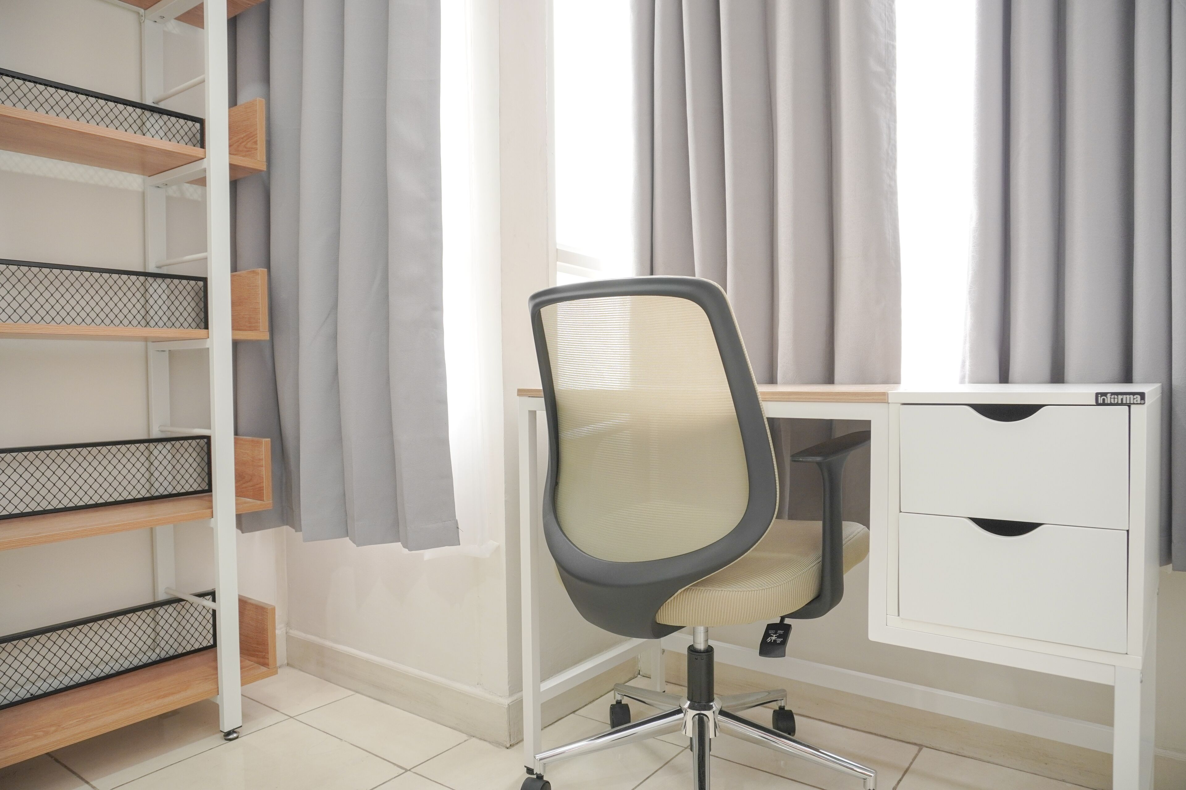 A workspace with a desk, chair, and shelving unit.