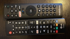 Two remote controls with various buttons and labels, including a Netflix button and an LG logo. - Minimalist Studio Room Marquis De Lafayette Apartment (Semarang)