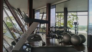 A gym with treadmills, dumbbells, and exercise balls. - Comfortable And Homey 1Br At Uttara The Icon Apartment (Depok)