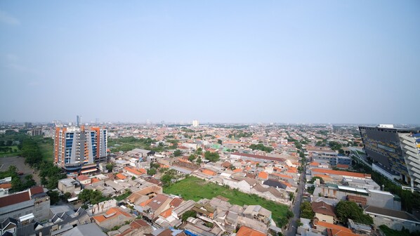 A cityscape with a mix of residential and commercial buildings, including a prominent high-rise with a unique architectural design.