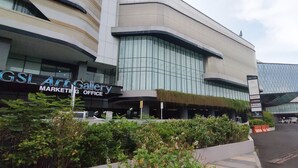 A modern building with a sign for GSL Art Gallery and a marketing office. - Good Choice And Homey 1Br Grand Sungkono Lagoon Apartment (Surabaya)